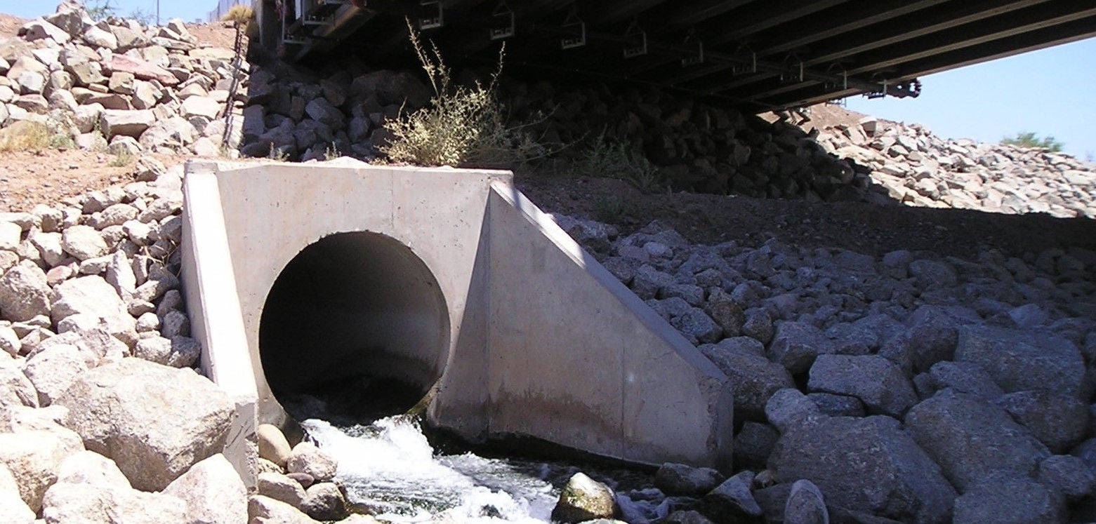 Water flowing through outfall channel into rocks